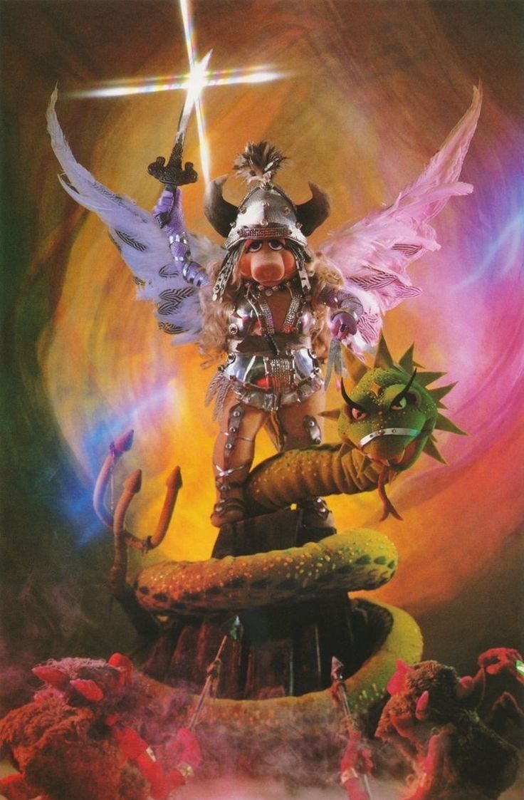 Miss Piggy in armour and wings holding a sword above her head. Below her, a dragon curls around a tower, and foes face her on the assault.